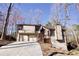 Two-story home featuring a two-car garage, brown trim, and lush trees at 4579 Glenforest Ne Dr, Roswell, GA 30075