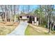 Two-story home featuring a two-car garage, brown trim, and lush green landscaping at 4579 Glenforest Ne Dr, Roswell, GA 30075