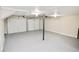 Spacious garage with two white doors, gray floors, and a support beam in the center of the room at 4579 Glenforest Ne Dr, Roswell, GA 30075