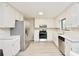 Bright kitchen with white cabinets, modern appliances, and hardwood floors at 4579 Glenforest Ne Dr, Roswell, GA 30075