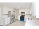 Bright kitchen features stainless steel appliances, white cabinets and countertops and modern flooring at 4579 Glenforest Ne Dr, Roswell, GA 30075
