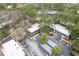 Aerial view of complex with ample parking, mature trees, and building with blue siding at 115 Woodmere Nw Sq # 115, Atlanta, GA 30327