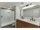 Modern bathroom features double vanity, sleek fixtures, and glass-enclosed shower with marble-style tile surround at 115 Woodmere Nw Sq # 115, Atlanta, GA 30327