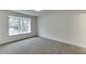 Bright bedroom featuring neutral carpeting and a large window allowing for ample natural light at 115 Woodmere Nw Sq # 115, Atlanta, GA 30327