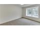 Bright bedroom featuring neutral carpeting and a large window allowing for ample natural light at 115 Woodmere Nw Sq # 115, Atlanta, GA 30327