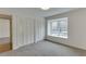 Bedroom showcasing soft carpeting, a built-in window seat, and large closet space for storage at 115 Woodmere Nw Sq # 115, Atlanta, GA 30327