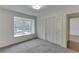 Bedroom showcasing soft carpeting, a built-in window seat, and large closet space for storage at 115 Woodmere Nw Sq # 115, Atlanta, GA 30327