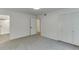 Bedroom featuring large closet space, doorway access and shower, and neutral carpeting at 115 Woodmere Nw Sq # 115, Atlanta, GA 30327