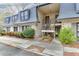 Attractive townhouse exterior with inviting landscaping, a brick facade, and a stairway to the front door at 115 Woodmere Nw Sq # 115, Atlanta, GA 30327