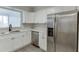 Modern kitchen with stainless steel appliances, white cabinets and counters, and a window at 115 Woodmere Nw Sq # 115, Atlanta, GA 30327