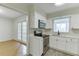 Stylish kitchen with stainless appliances and natural light flowing into the adjacent dining room at 115 Woodmere Nw Sq # 115, Atlanta, GA 30327