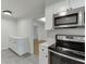 Well-lit eat-in kitchen boasts stainless steel appliances and bright white cabinetry at 115 Woodmere Nw Sq # 115, Atlanta, GA 30327
