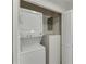 Compact laundry closet with stacked washer and dryer at 115 Woodmere Nw Sq # 115, Atlanta, GA 30327