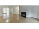 Spacious living room featuring gleaming hardwood floors, a fireplace, and sliding doors leading to another room at 115 Woodmere Nw Sq # 115, Atlanta, GA 30327