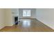 Elegant living room featuring polished hardwood floors and a classic fireplace with a black marble surround at 115 Woodmere Nw Sq # 115, Atlanta, GA 30327