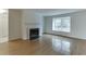 Inviting living room with a cozy fireplace, hardwood floors, and a large window for natural light at 115 Woodmere Nw Sq # 115, Atlanta, GA 30327
