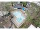 Aerial view of community pool surrounded by concrete decking and mature trees at 115 Woodmere Nw Sq # 115, Atlanta, GA 30327