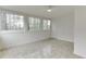 Bright sunroom featuring tile flooring and large windows for natural light and scenic views at 115 Woodmere Nw Sq # 115, Atlanta, GA 30327