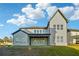 Back exterior view showcasing a two-story home, a covered patio, and a large grassy yard at 1925 Harken Grv, Marietta, GA 30064