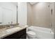 Bathroom featuring granite vanity, and textured tile surrounding the bathtub and shower at 1925 Harken Grv, Marietta, GA 30064