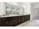 Spacious bathroom with double sinks, granite countertops, dark wood cabinets, and large mirror at 1925 Harken Grv, Marietta, GA 30064