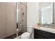 Modern bathroom features a glass-enclosed shower with textured tile surround and granite topped vanity at 1925 Harken Grv, Marietta, GA 30064