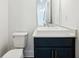 Charming powder room with navy blue vanity, vessel sink, and modern fixtures at 1925 Harken Grv, Marietta, GA 30064