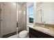 Modern bathroom features a glass-enclosed shower with gray textured tiling and a granite vanity at 1925 Harken Grv, Marietta, GA 30064