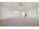 Spacious primary bedroom with neutral carpet, ceiling fan, and tray ceiling at 1925 Harken Grv, Marietta, GA 30064