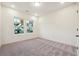 Bright bedroom featuring neutral carpet, white walls, a window with backyard views, and ample space at 1925 Harken Grv, Marietta, GA 30064