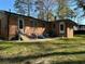 Relaxing backyard featuring a brick home and patio with comfortable outdoor furniture at 4063 Windsor Castle Way, Decatur, GA 30034
