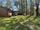 Spacious backyard perfect for outdoor gatherings with a brick home and wooded backdrop at 4063 Windsor Castle Way, Decatur, GA 30034