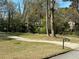 Long driveway leading to a basketball hoop, all set amongst mature trees at 4063 Windsor Castle Way, Decatur, GA 30034