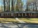 Charming brick ranch home with a manicured front lawn and inviting walkway at 4063 Windsor Castle Way, Decatur, GA 30034
