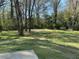 Expansive green yard adorned with mature trees providing a serene outdoor space at 4063 Windsor Castle Way, Decatur, GA 30034