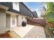 Brick patio in private backyard and view of exterior with access to the rear of the house at 5210 Chemin De Vie, Atlanta, GA 30342