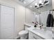 Bathroom with a modern vanity, a large mirror, updated fixtures, and white cabinets at 5210 Chemin De Vie, Atlanta, GA 30342