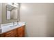 Powder room features a stylish mirror, modern light fixture, and vanity with a white countertop at 5210 Chemin De Vie, Atlanta, GA 30342