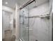 Walk in shower features glass doors, rainfall shower head and white tile at 5210 Chemin De Vie, Atlanta, GA 30342