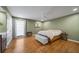 Spacious primary bedroom with hardwood floors, ceiling fan and closet at 5210 Chemin De Vie, Atlanta, GA 30342