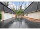 Driveway leading to two-car garages; view of exteriors and landscaping at 5210 Chemin De Vie, Atlanta, GA 30342