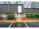 Charming townhome featuring a well-maintained exterior with brick facade and manicured landscaping at 5210 Chemin De Vie, Atlanta, GA 30342