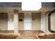 Close up showing a brick facade and the front door entrance to this townhome at 5210 Chemin De Vie, Atlanta, GA 30342