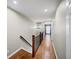 Upstairs hallway features hardwood flooring and neutral paint at 5210 Chemin De Vie, Atlanta, GA 30342