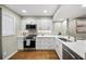 Beautiful kitchen boasting white cabinets, quartz countertops, and stainless steel appliances at 5210 Chemin De Vie, Atlanta, GA 30342