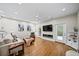 Bright living room features a fireplace, large TV, ceiling fan, and access to the outdoors at 5210 Chemin De Vie, Atlanta, GA 30342