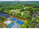 An aerial view of the community with a golf course, swimming pool, tennis courts, and a pond with a fountain at 5729 Brookstone Nw Walk, Acworth, GA 30101