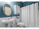Bathroom featuring a pedestal sink, blue walls, and a shower/tub combo at 5729 Brookstone Nw Walk, Acworth, GA 30101