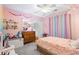 Whimsical pink bedroom with rainbow curtains and a cozy bed at 5729 Brookstone Nw Walk, Acworth, GA 30101