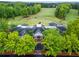An aerial shot showcases a clubhouse with well-maintained landscaping and a circular driveway at 5729 Brookstone Nw Walk, Acworth, GA 30101